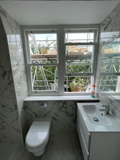 Luxury en-suite bathroom refit with marble-effect tiling in London